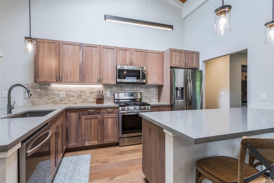 Stainless steel appliances in the large, spacious kitchen.