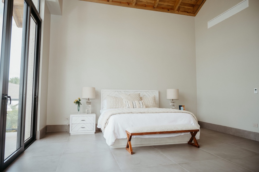 Cozy guest bedroom with modern decor and plush bed.