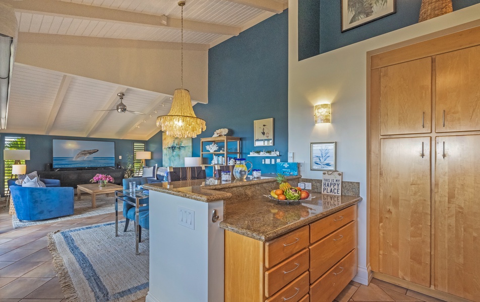 A kitchen island with extra counter space, flowing into a cozy living area.