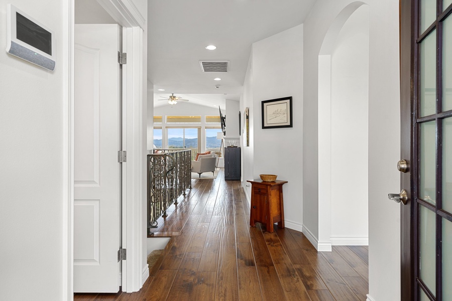 Journey through the inviting main floor hallway, leading the way to the master bedroom's entrance, adjacent to the staircase