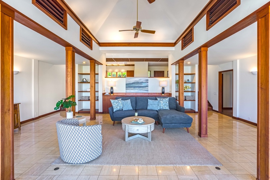 Stunning great room featuring vaulted ceilings with the dining room and kitchen behind