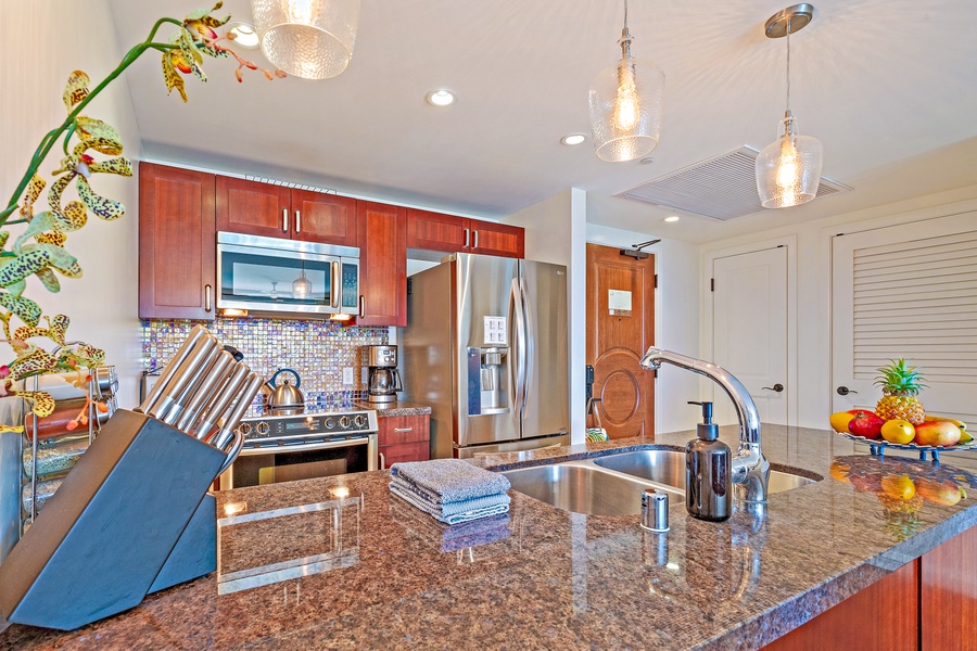 The kitchen island with its granite countertop and modern fixtures offers ample space for meal prep