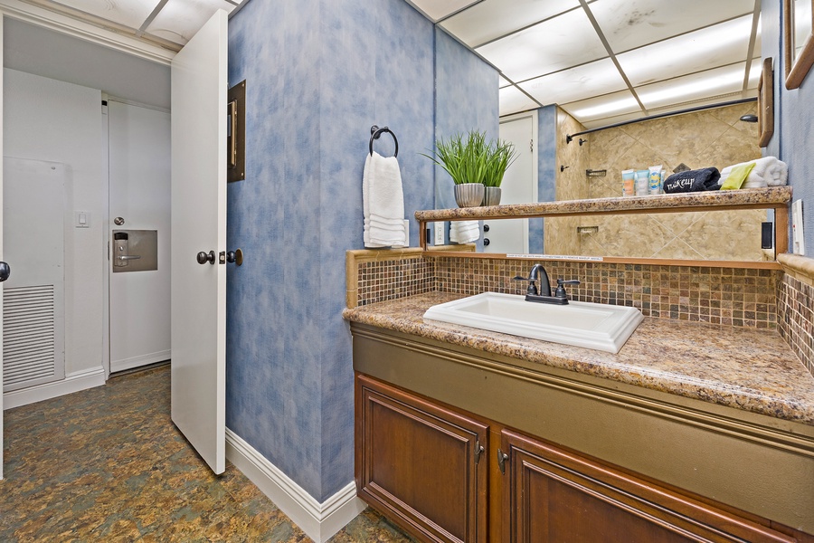 The bathroom offers a stylish vanity with a modern sink and sleek fixtures, perfect for refreshing after a day of adventure.