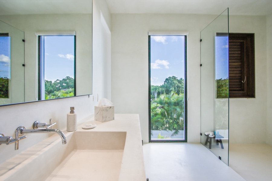 Freshen up in the ensuite bathroom with a clean, modern design and large windows.