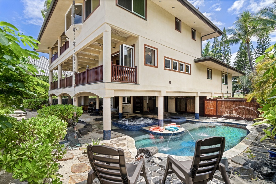 Backyard oasis with swim-up bar, spa, and covered seating—designed for endless family fun.
