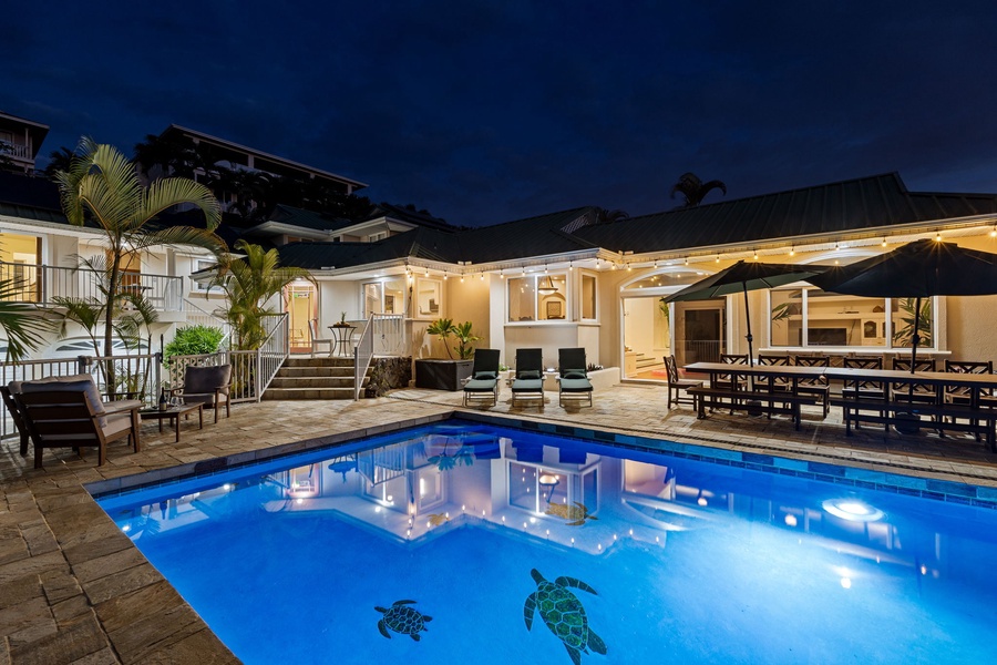 Stunning pool villa illuminated at night, featuring elegant outdoor spaces perfect for evening entertaining.