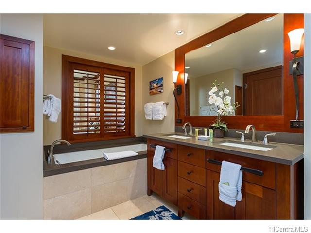 Bathroom with dual vanities and a soaking tub.