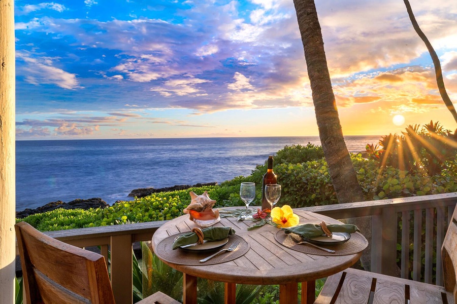 Romantic round-table lanai setup under palm trees at golden hour.