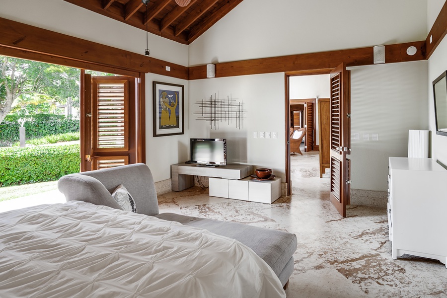 The suite featuring natural light, elegant furnishings, and direct garden access.