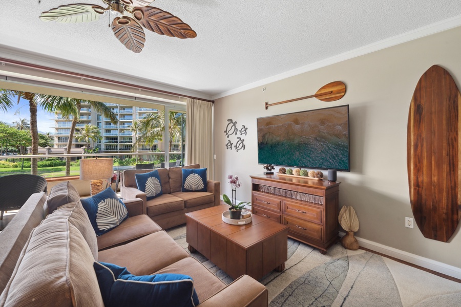 Relax in island-style comfort in the living room of Honua Kai Konea 204, complete with tropical decor and a large flat-screen TV for cozy evenings.