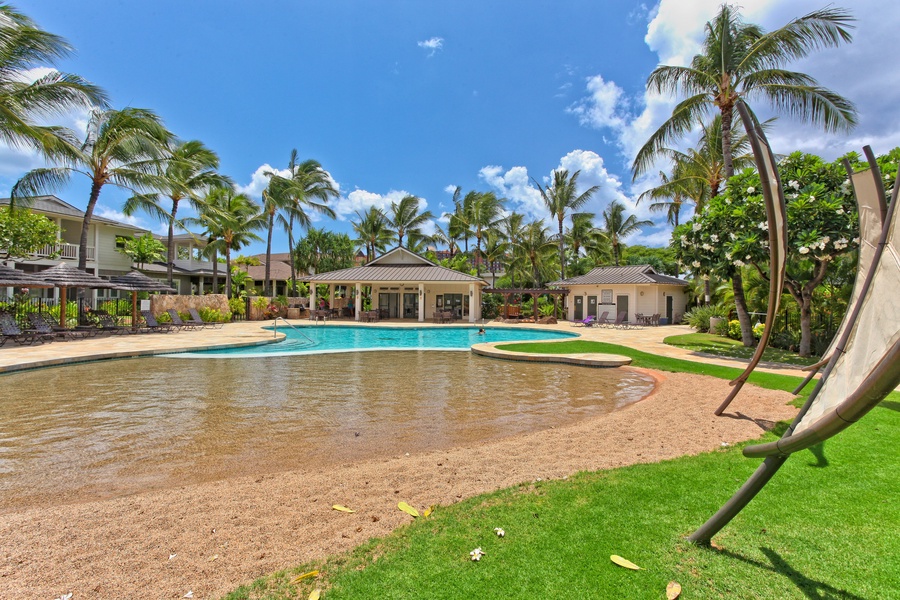 The area also features a sand bottom pool nestled under swaying palm trees.