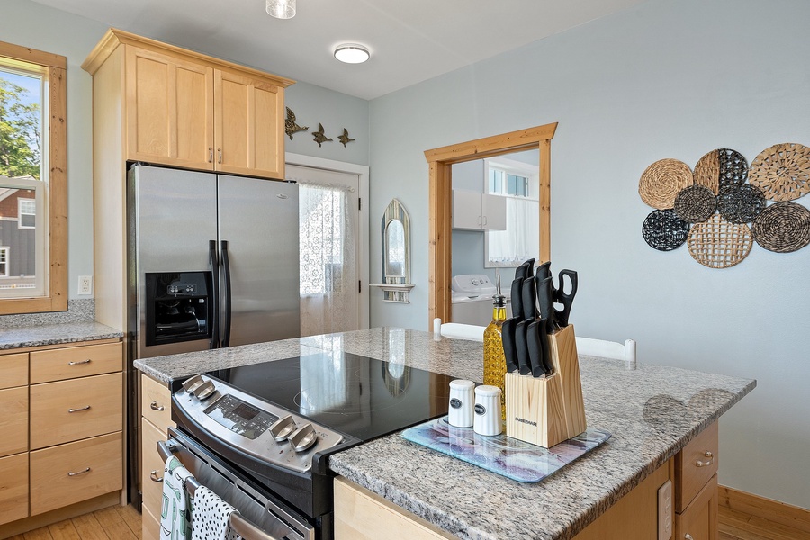 Modern kitchen setup with sleek induction cooker and spacious double-door fridge