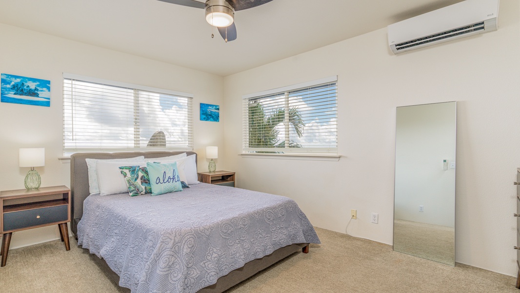 Primary bedroom with a cozy queen bed with lots of natural lights and views.
