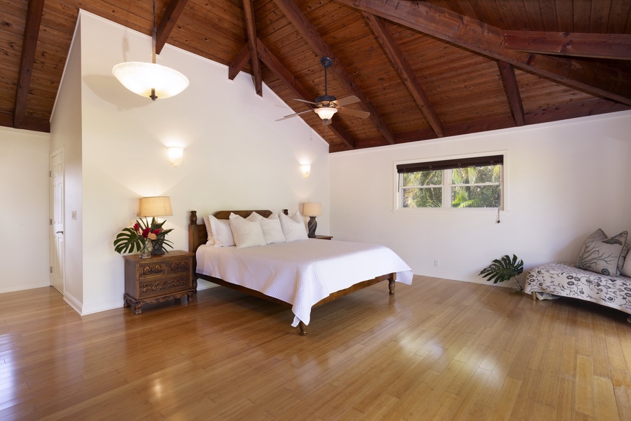 Spacious and airy primary guest suite with a Cal King bed and lofted ceilings