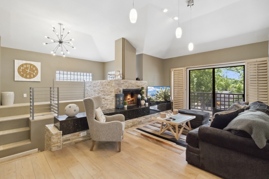As you walk into the expansive living area with a cozy fireplace, you will notice the large windows that provide abundant natural light, bringing in all the warmth and sunshine of Arizona