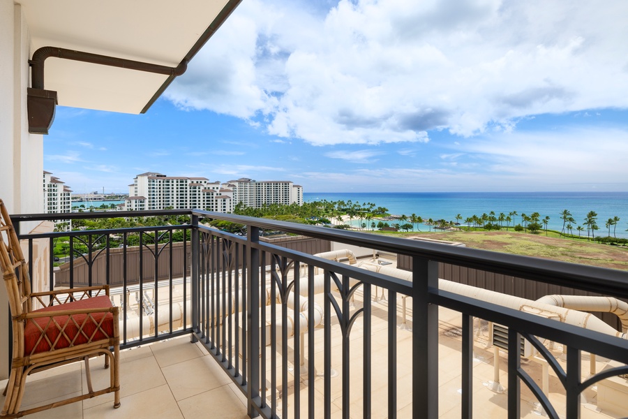 Panoramic ocean views stretch endlessly from this private lanai, where tropical palms frame turquoise waters below.