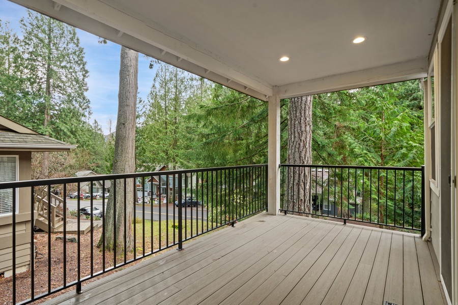 Enjoy your morning coffee on this peaceful covered lanai, surrounded by towering trees and tranquil neighborhood views.