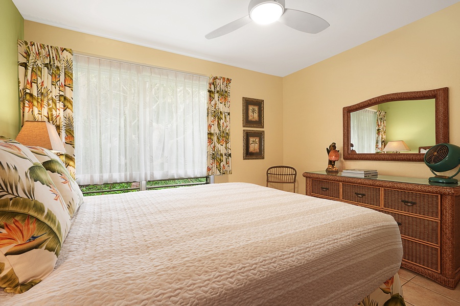 The guest bedroom has large windows and plenty of natural light.