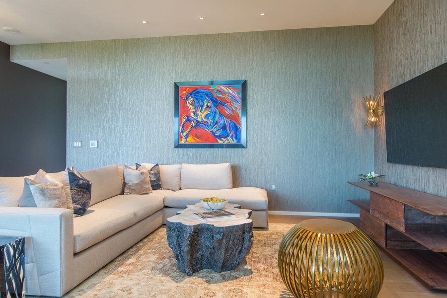 Plush cushions while vibrant art and golden accents create your perfect retreat for relaxing evenings.