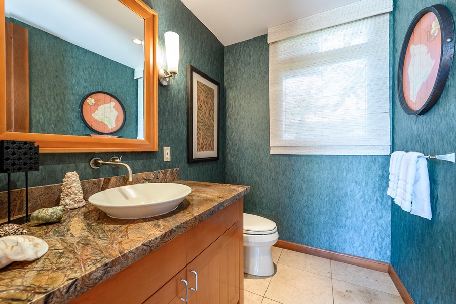 A convenient guest powder room is centrally located.