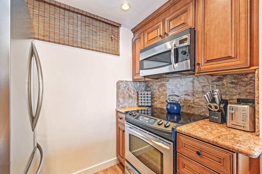 The well-equipped kitchen features modern appliances and granite countertops, making meal prep easy and enjoyable