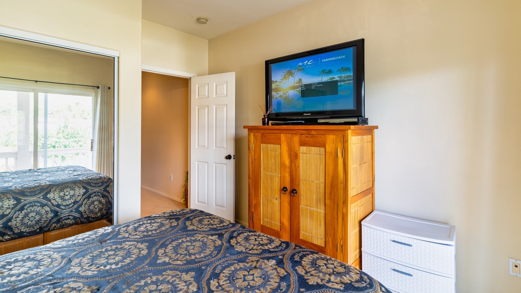 The spacious second guest bedroom with a TV.