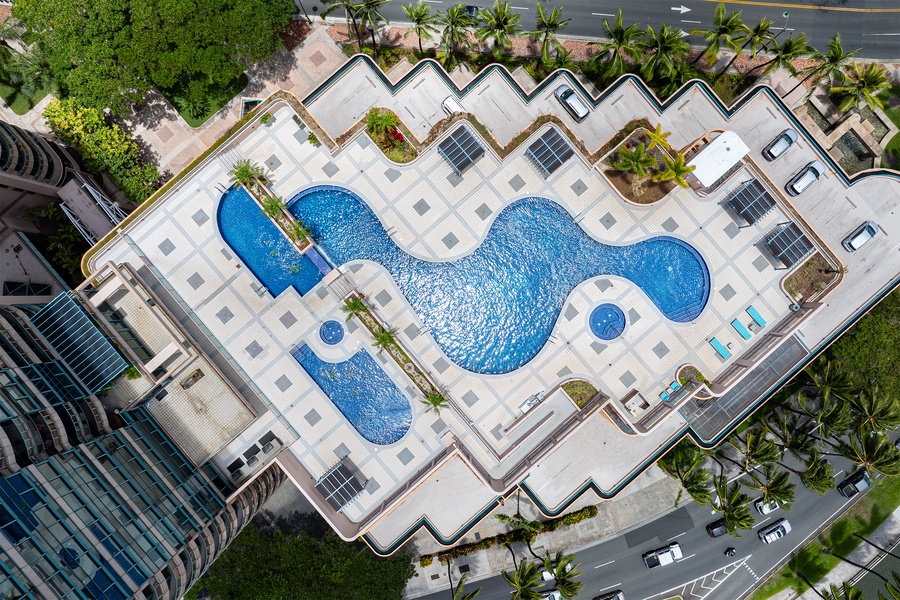 From above, the pool traces one long curve across the open deck high over the city.