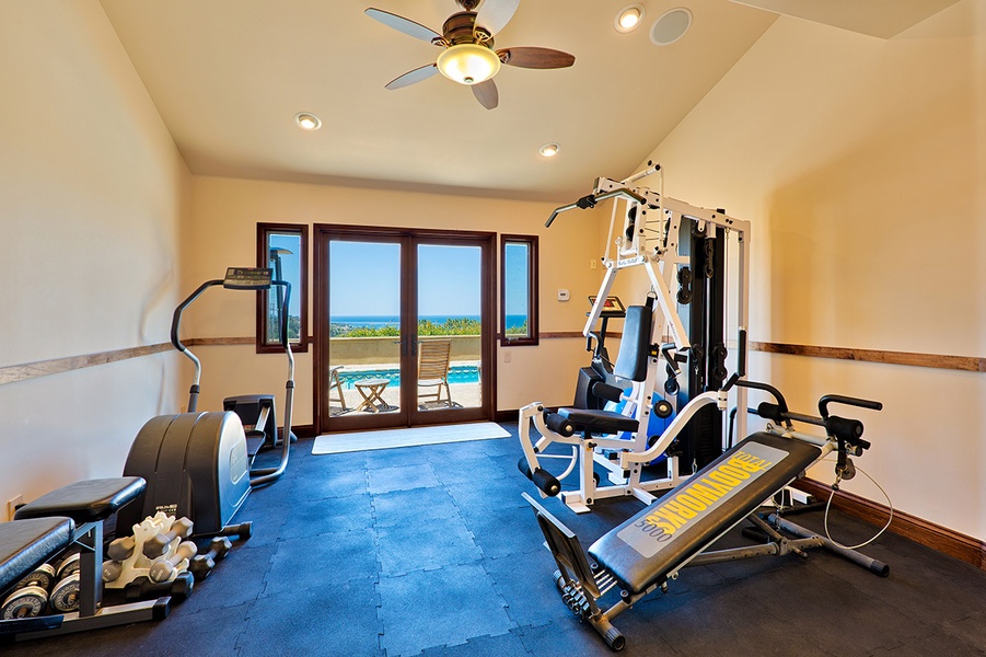 Fully equipped gym with ocean and pool views