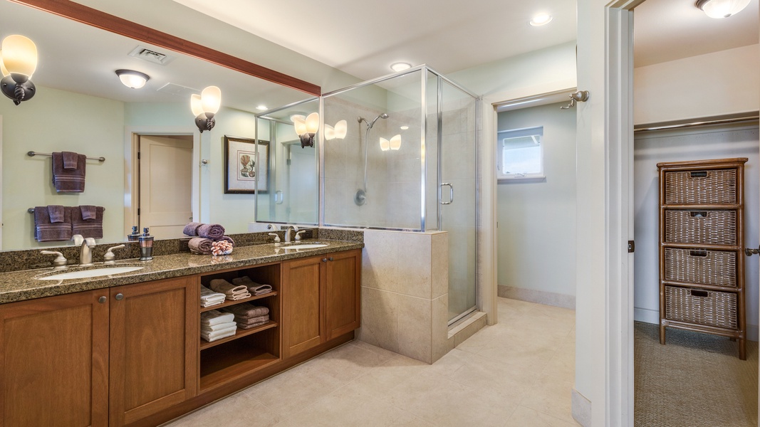 Primary bath w/ walk-in shower and dual sinks, separate toilet room and walk-in closet.