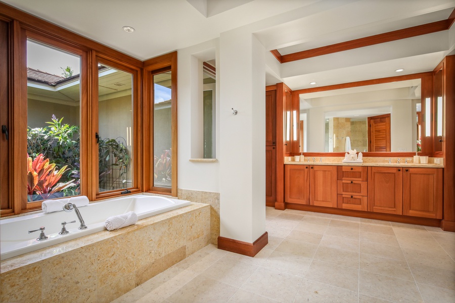 Primary bath with oversized soaking tub, dual vanity, walk-in shower, and outdoor shower garden.