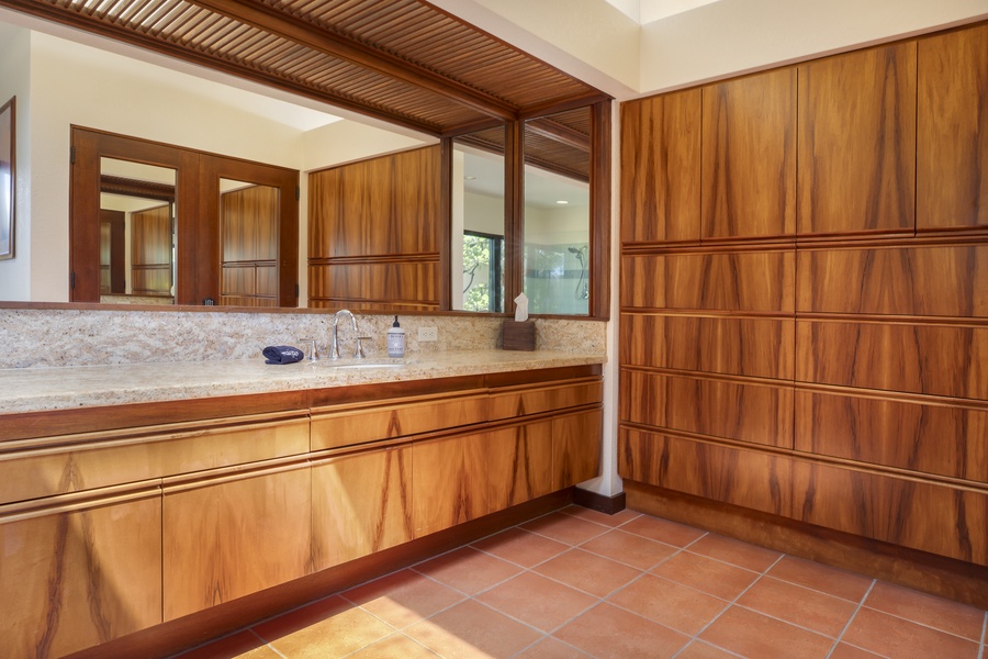 Luxurious double vanity with full mirrors and rich wood finishes, enhancing your stay with comfort and style.