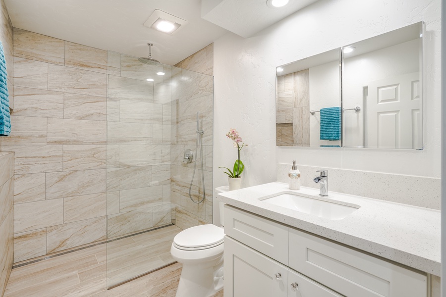 Shared bathroom with a walk-in shower