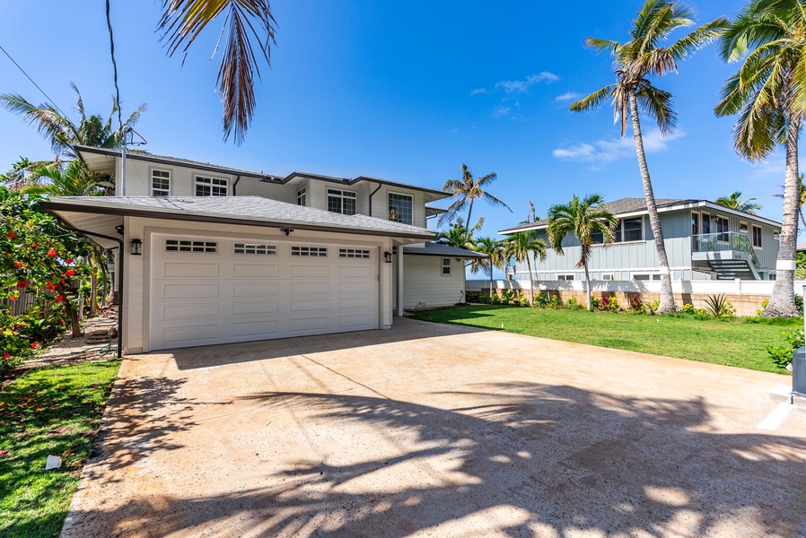 The private gated entrance welcomes you to your coastal oasis with tropical landscaping and curb appeal.