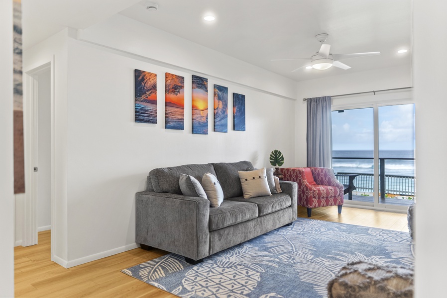 Comfortable seating area accented with coastal artwork, perfect for unwinding after exploring Haleiwa’s beaches and cafés.