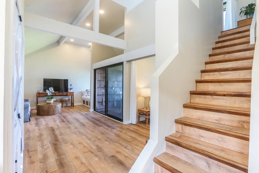 Head upstairs from main living space to the additional guest bedroom