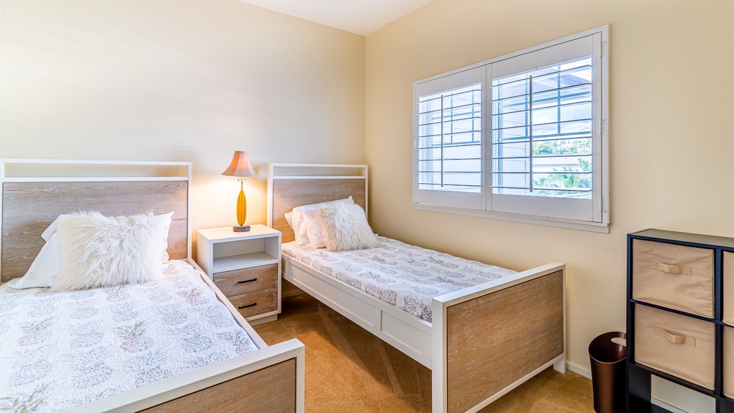 The very inviting third guest bedroom with soft lighting and scenery.
