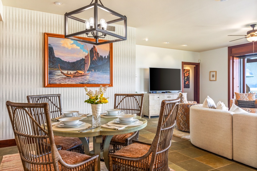 Alternate view of dining table with valuable artwork pictured behind.