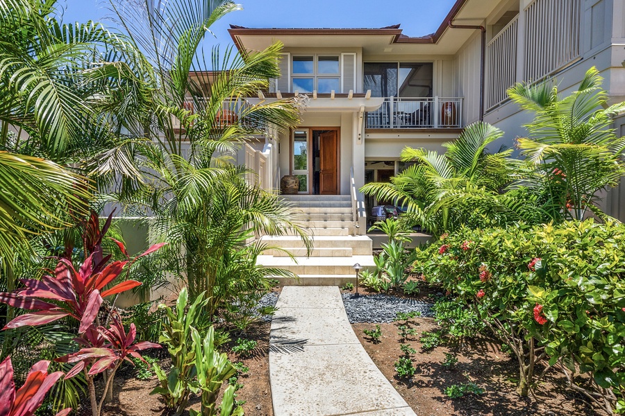 Entryway to front of townhome with tropical landscaping.