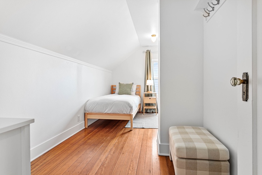 Clean lines and hardwood floors add timeless appeal to this upper-level hallway and bedroom entry.