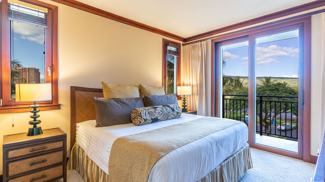 The primary guest bedroom boasts comfort, style, a king-sized bed and a private lanai with scenic views.