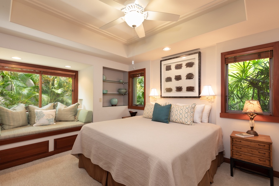 Doze off in your peaceful King bedroom sanctuary with tropical garden views, plush linens, and a cozy window seat perfect for morning coffee.