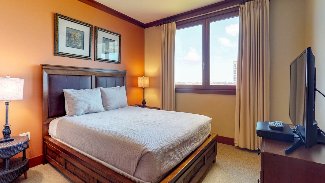 The second bedroom boasts a queen platform bed and views.