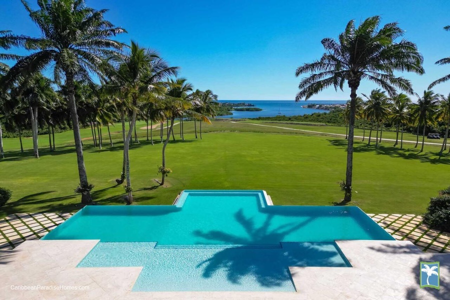 Dive into the infinity pool with breathtaking views of the ocean and lush golf course.