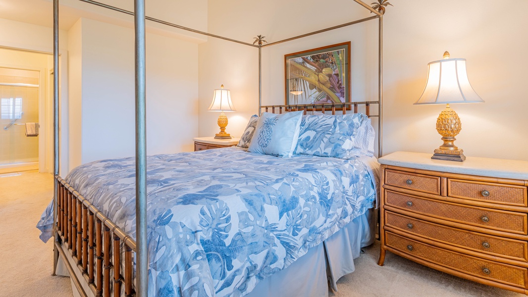 The primary guest bedroom is spacious with soft linens and framed art.