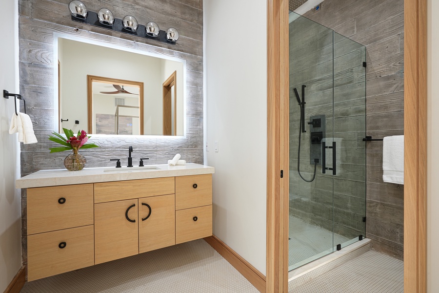 Indulge in the sleekness of this ensuite, boasting a spacious walk-in shower and a vanity.