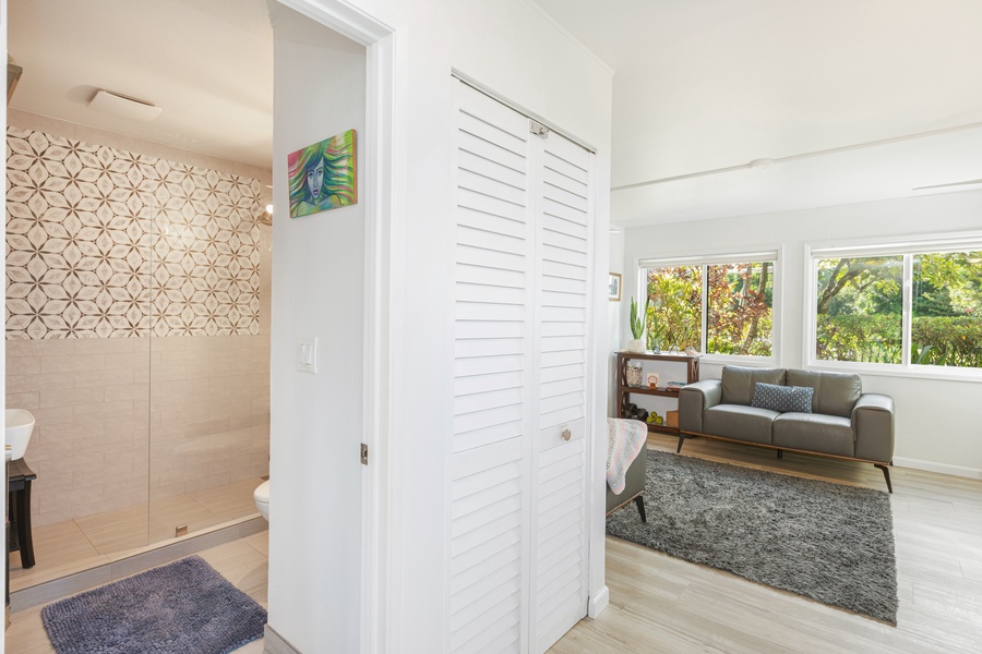 Downstairs shared bathroom features a walk-in shower with modern tile and natural light.