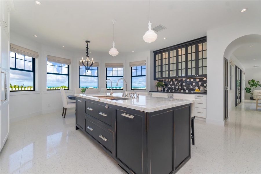 Central island anchors the kitchen with seating and storage, perfect for entertaining.