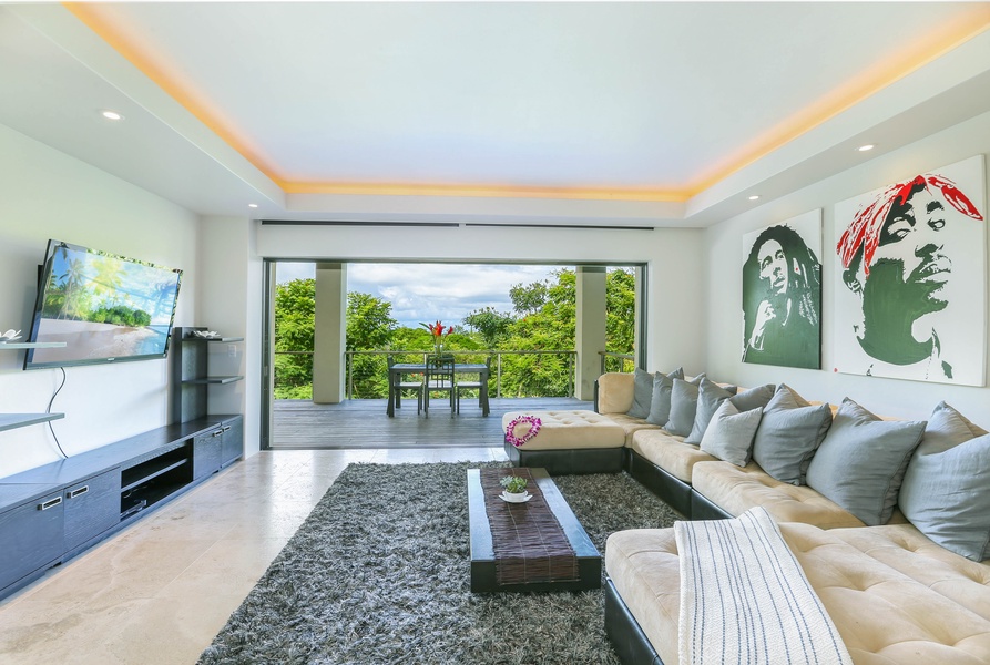 Spacious living room has direct access to lanai.