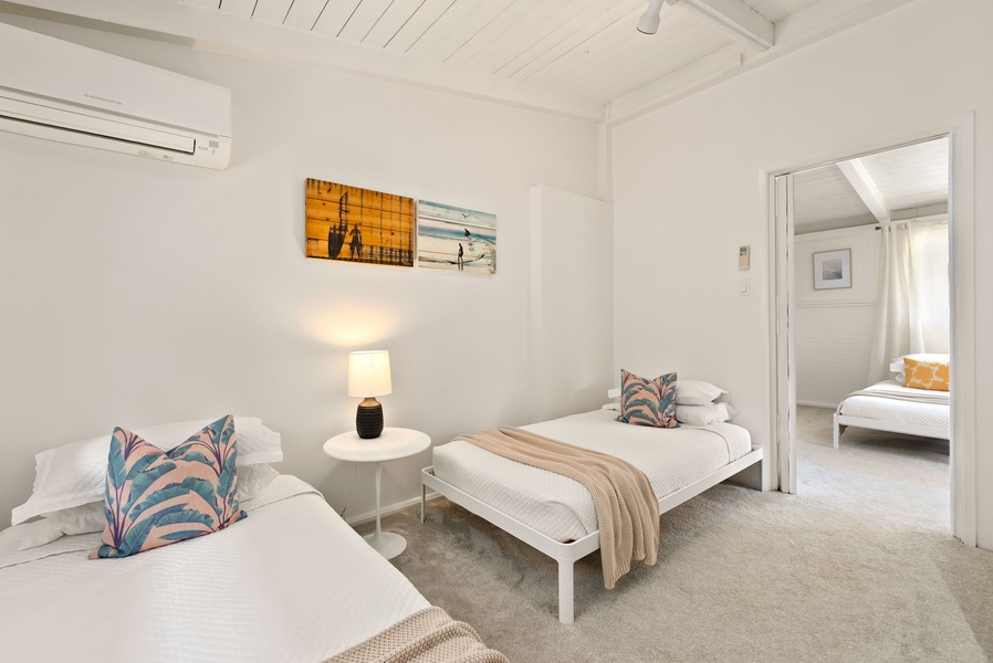 Sink into crisp white linens and let coastal artwork transport you. Two comfy beds ensure everyone sleeps soundly while the nearby bedroom offers even more space to spread out.