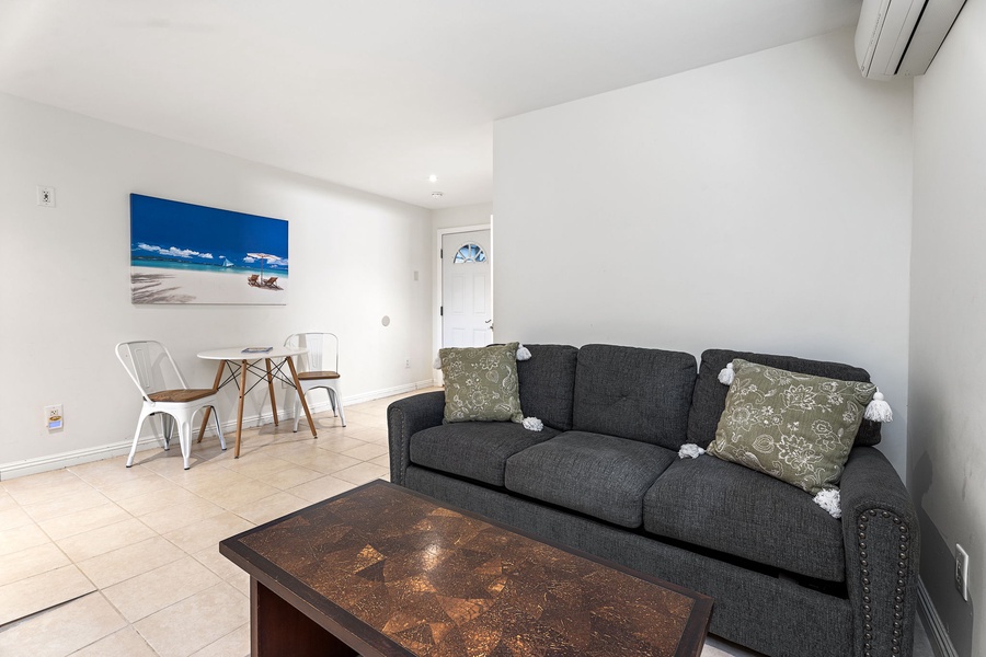 Unwind in your bright, modern media room with comfortable seating and coastal artwork that brings beachside vibes indoors.